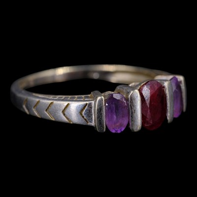 Lot 1338 - A vintage ruby and amethyst three-stone...