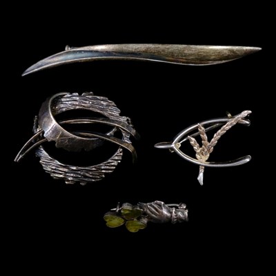 Lot 1274 - Four vintage silver / white metal brooches,...