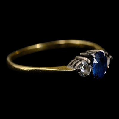 Lot 1405 - A 1980s three-stone diamond and sapphire...
