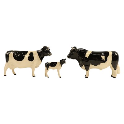 Lot 1083 - A Beswick Friesian cattle group, including...