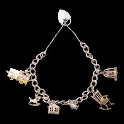 Lot 1284 - A vintage silver charm bracelet, 28 g