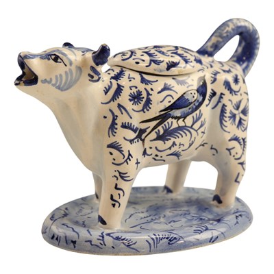 Lot 970 - A Dutch Delft pottery cow creamer, 11 cm high
