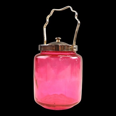 Lot 1109 - A cranberry glass biscuit barrel, having...