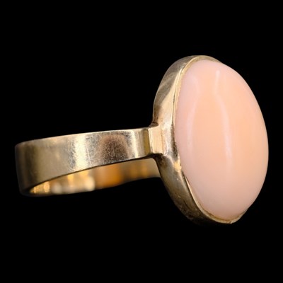 Lot 1435 - A 1970s coral and 9 ct gold ring, comprising...