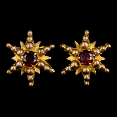 Lot 1451 - A pair of 1960s garnet and 9 ct gold starburst...