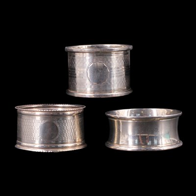 Lot 1214 - Three various silver napkin rings, 61 g