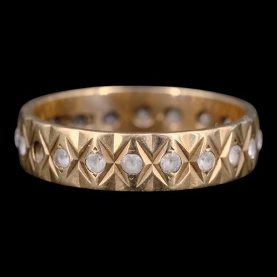 Lot 1409 - A 1990s white gemstone and 9 ct gold eternity...