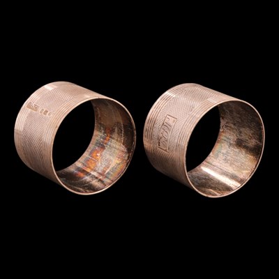 Lot 1225 - A pair of 1940s silver napkin rings, each...