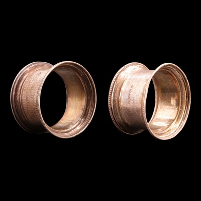 Lot 1226 - A pair of 1930s silver napkin rings, each...