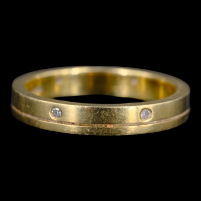 Lot 1519 - A contemporary diamond and 18 ct gold eternity...