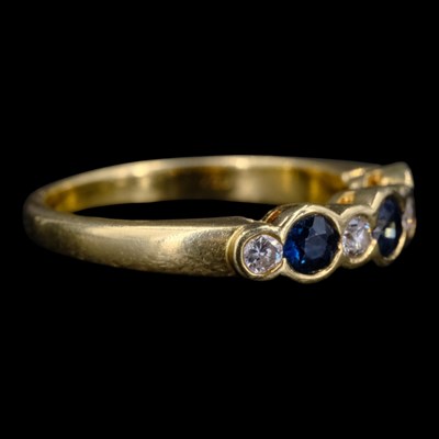 Lot 1520 - A contemporary sapphire and diamond ring,...