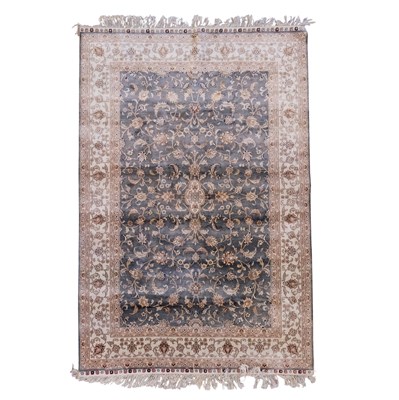 Lot 1664 - A Persian hand-knotted silk rug, having...