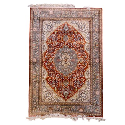 Lot 1665 - A Persian hand-knotted silk rug, having...