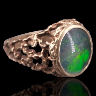 Lot 1264 - A 1970s opal triplet ring, comprising an oval...