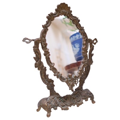 Lot 862 - A Rococo style brass dressing table mirror,...