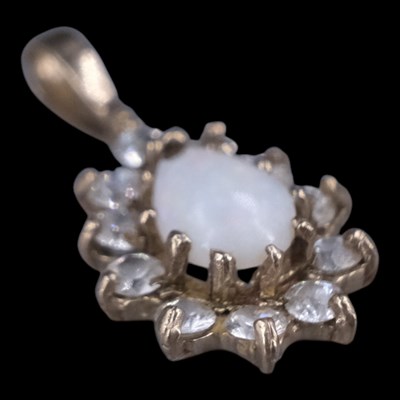Lot 1328 - A late 20th Century opal and white gemstone...