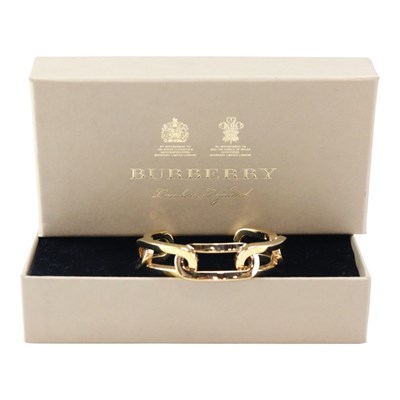 Lot 806 - A Burberry gold-tone chain cuff bangle, in...