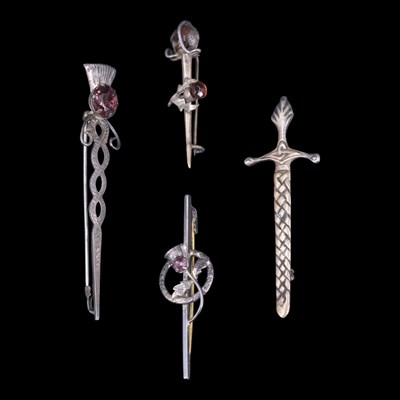 Lot 1231 - Four Scottish silver / white metal bar...