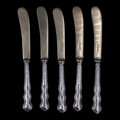 Lot 1105 - Five Edwardian silver-handled butter...
