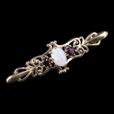 Lot 1366 - A late 20th Century opal, almandine and 9 ct...