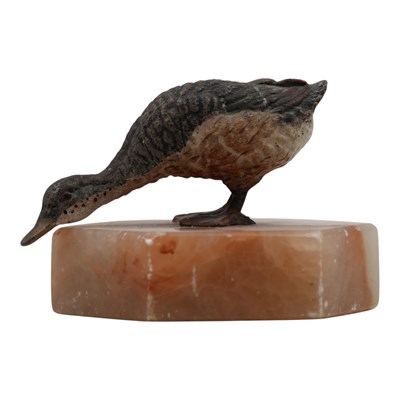 Lot 1494 - A cold-painted duck, on hexagonal onyx base,...