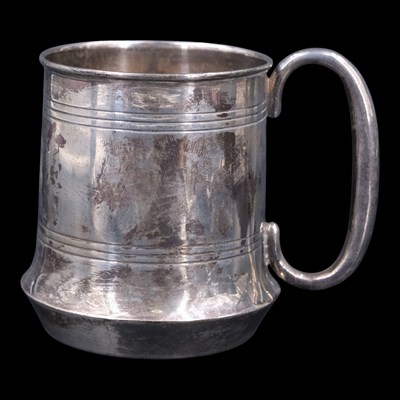 Lot 1075 - A 1920s silver christening mug, bearing an...