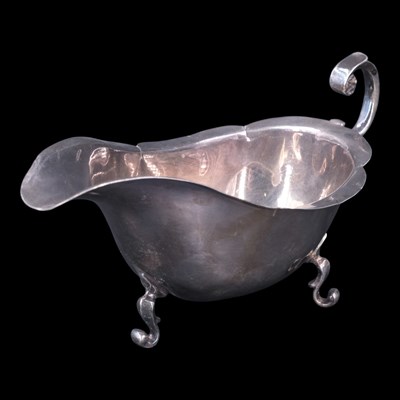 Lot 1078 - A 1920s silver sauce boat, having a cusped rim,...