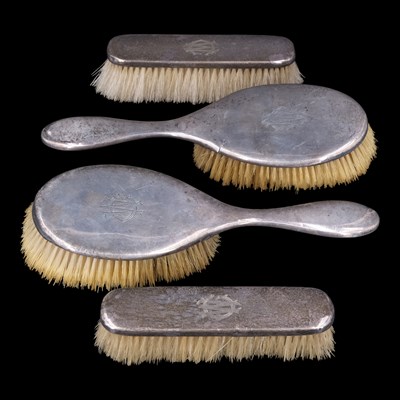 Lot 1129 - A George V four-piece silver-mounted dressing...