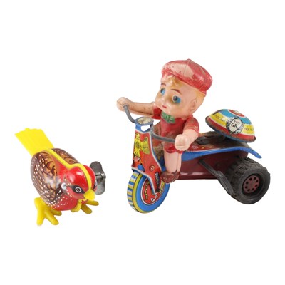 Lot 755 - Two mid-20th Century clockwork tinplate toys,...
