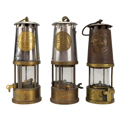 Lot 628 - Three Prestwich's patent miners' lamps, approx...