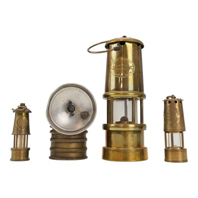 Lot 629 - Three miniature miners' lamps, together with a...