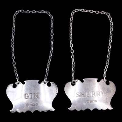 Lot 1102 - A pair of QEII silver decanter labels, fancy...