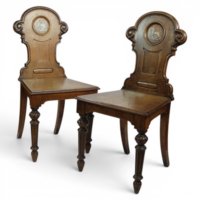 Lot 1651 - A pair of Victorian oak hall chairs by...